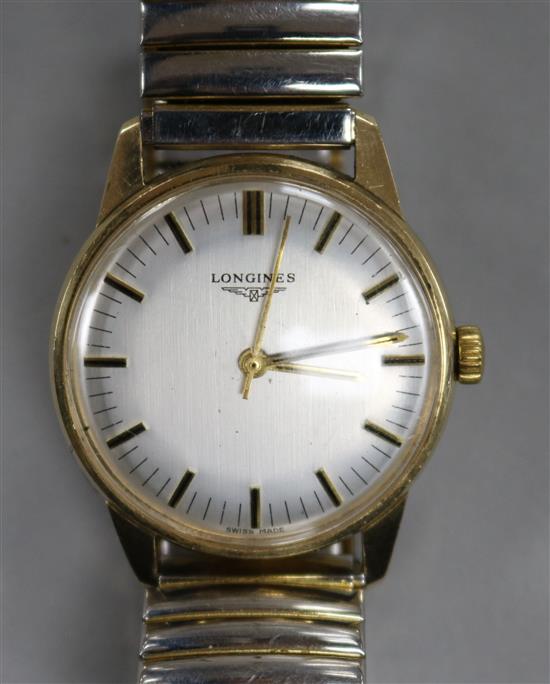 A gentlemans 9ct gold Longines manual wind wrist watch.